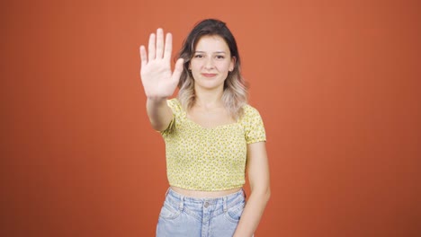 Young-woman-making-stop-sign-for-camera.